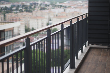 Modern balcony overlooking urban cityscape during daytimeの写真素材