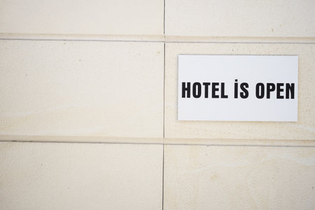 Hotel open sign displayed on a building wallの写真素材