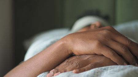 Person resting peacefully in bed during morning lightの写真素材