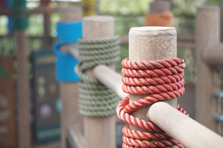 Rope wrapped around wooden posts in an outdoor settingの写真素材