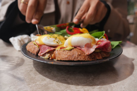 Enjoying a delicious brunch with eggs and greensの写真素材