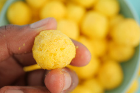 Delicious yellow snack balls enjoyed at a festive gatheringの写真素材