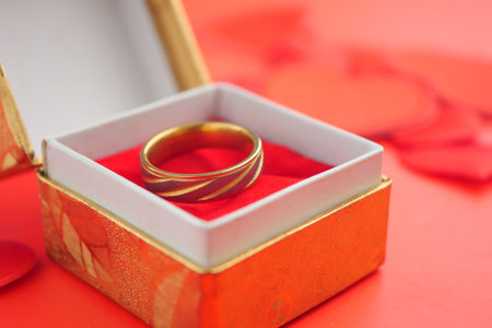 Gold ring displayed in a red box for special occasionの写真素材