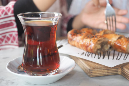 Enjoying tea and pastry in a cozy cafe settingの写真素材