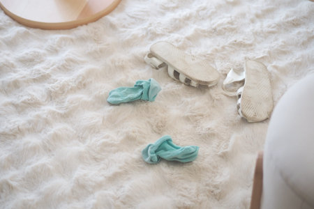 Kids shoes and socks on living room carpet