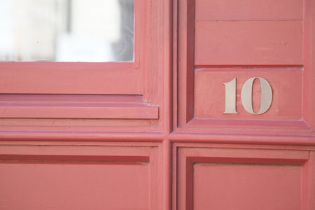 House number ten on a colorful door in an urban settingの写真素材