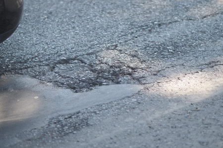 Pothole on a city street seen during daylight hours