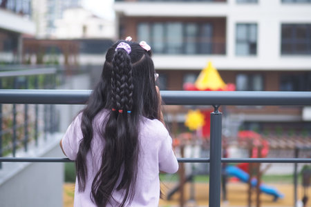 Child enjoys outdoor playground view on a sunny dayの写真素材