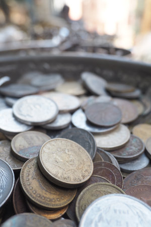 Collection of old coins displayed in a market stallの写真素材