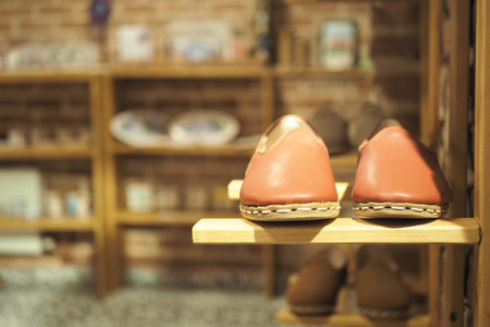Handcrafted shoes displayed in a cozy shop environmentの写真素材