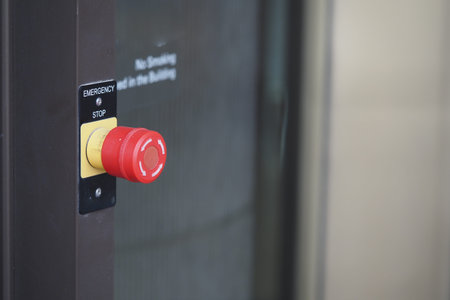 Emergency stop button in a public building hallway