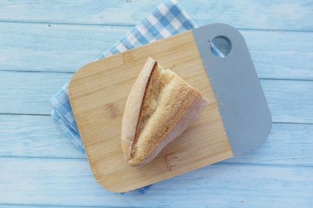 Freshly baked bread resting on a wooden cutting board