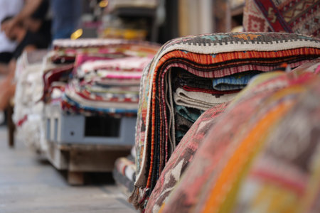 Colorful rugs displayed at a market in a vibrant bazaar