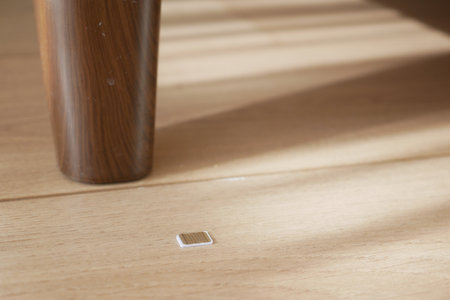 phone sim card lies on the wooden floor. lost sim card conceptの写真素材