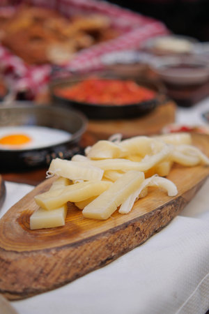 Delicious cheese preparation on a wooden board