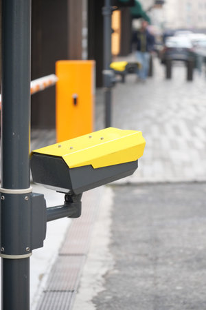 Yellow parking sensor installed on a city street