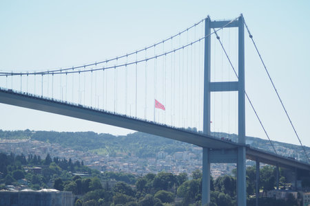 Flag displayed on a bridge in a sunny city setting in istanbulの写真素材