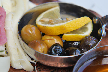 Delicious selection of olives and lemon slices served freshの写真素材