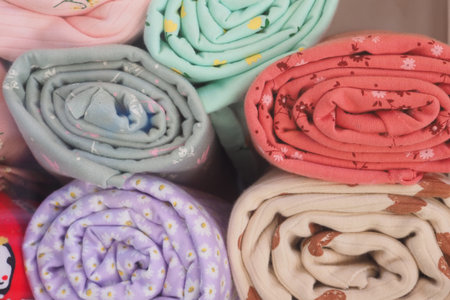 Soft and colorful rolled fabrics in a cozy displayの写真素材