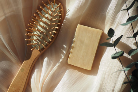 Natural hair care tools on a soft fabric surfaceの写真素材