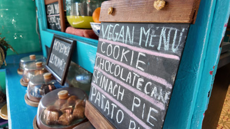 Vegan menu highlighting options at a cozy cafe counter