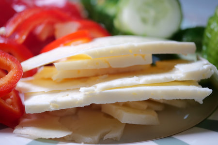 Colorful fresh vegetables and cheese on a plate for a meal