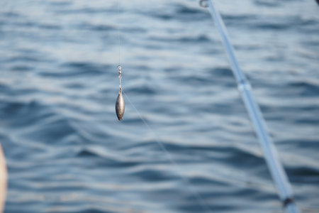 Fishing tackle hanging over the calm water in the afternoon