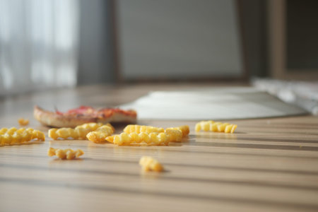Snack leftovers on a wooden table in a bright room
