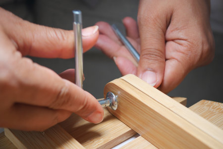 Hands assembling a wooden project in a workshopの写真素材