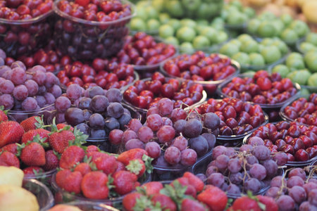 Fresh fruits displayed in colorful market basketsの写真素材