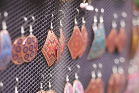 Colorful earrings displayed at a craft market in autumn