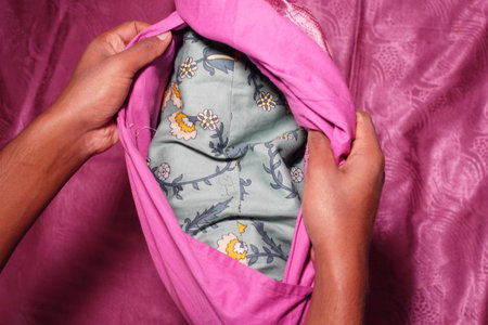 hand removing the pillow case from a pillow