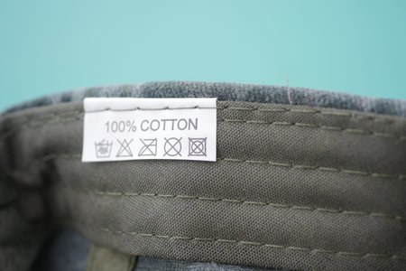 Cotton label showing care instructions for clothing fabric