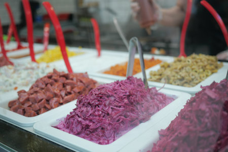 Colorful display of toppings in a food market stallの写真素材
