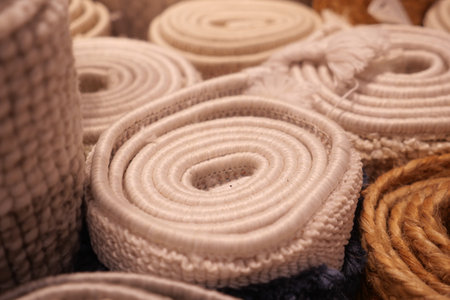Coiled textile rolls displayed at a market stallの写真素材