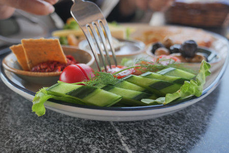 Fresh salad served on a plate at a casual dining tableの写真素材