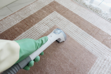 Cleaning carpet with vacuum in a living roomの写真素材
