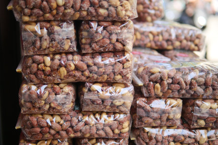 Packed snacks displayed at a market in daylightの写真素材