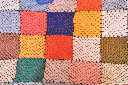 Colorful crochet blanket displayed on a table