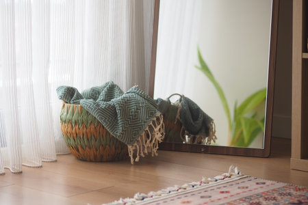 Cozy corner with a woven basket and a large mirror