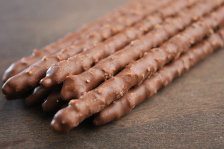 Chocolate covered snacks arranged on a wooden surface