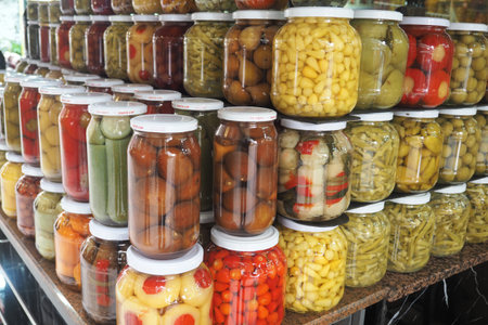 Colorful pickled vegetable jars at the marketの写真素材