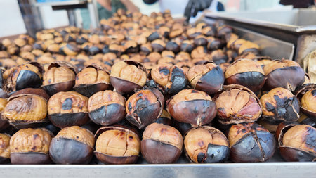 Roasted chestnuts displayed in a market settingの写真素材