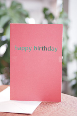 Birthday card with simple design on a wooden tableの写真素材