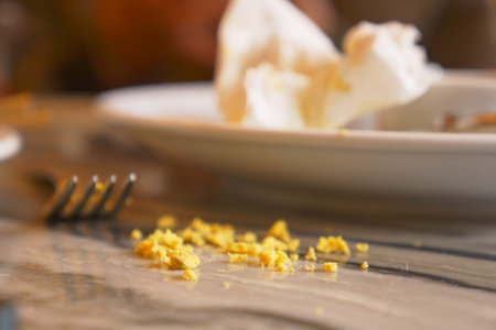 Crumbs on table after a meal at a restaurant setting