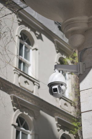 Security camera watches over a historic building exteriorの写真素材