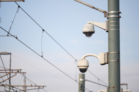 Security cameras monitoring a train station environmentの写真素材
