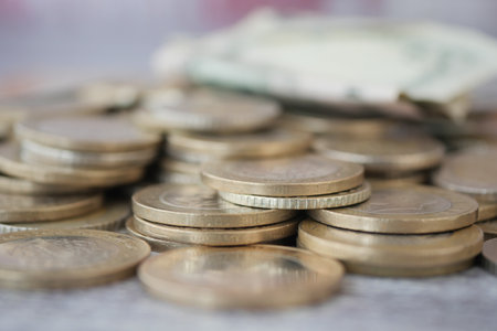 Various coins and paper money on a flat surfaceの写真素材