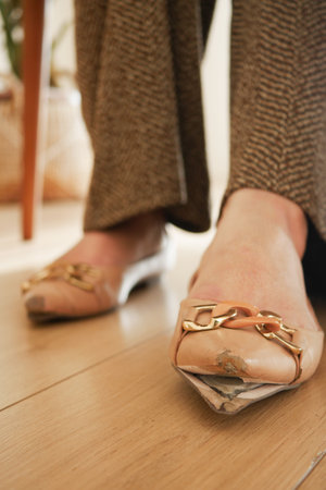 Elegant flat shoes close-up on wooden floorの写真素材