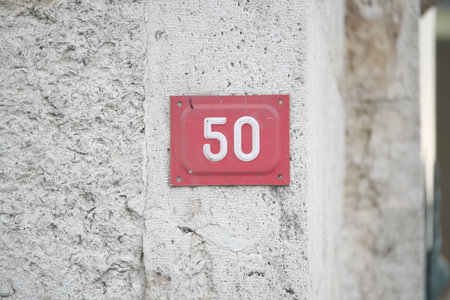 House number 50 marked on a textured wallの写真素材